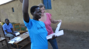 Beth helps a community health worker mobilize Rwandan citizens.